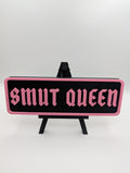 Pink Smut Queen Street Sign